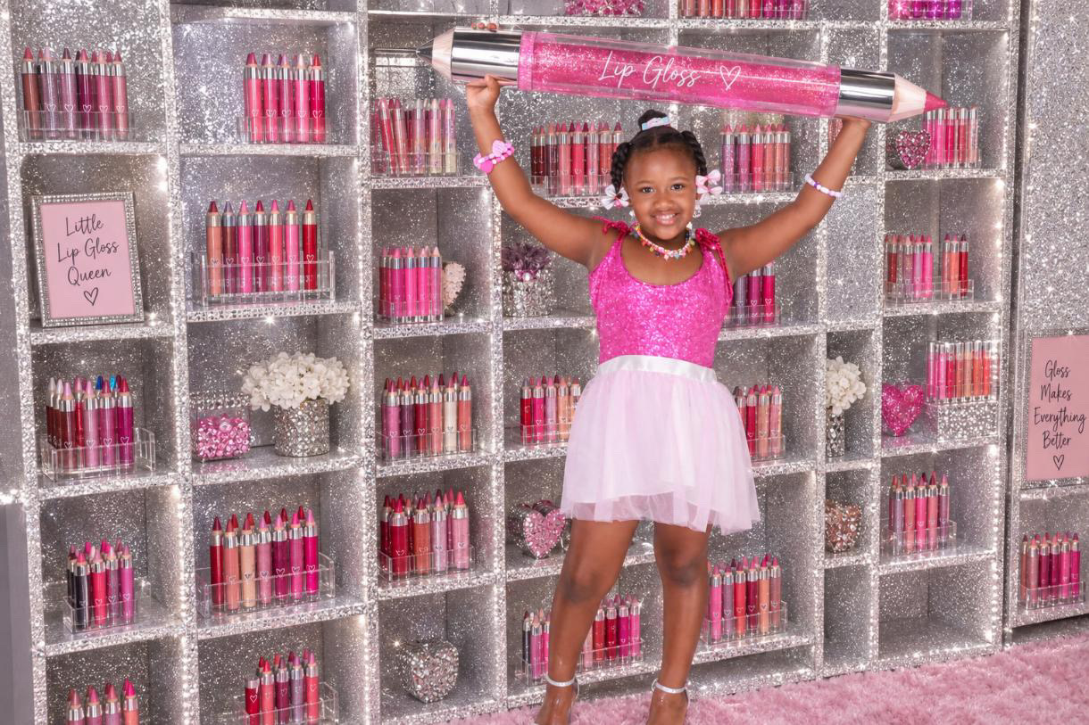 Zoey holding a giant lip gloss